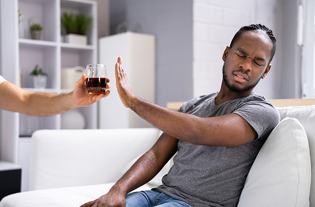 Man refusing a drink of alcohol