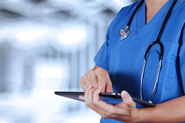 Image of nurse in uniform with stethescope with electronic tablet