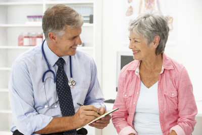 Image of GP speaking with a patient in his consulting room